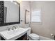 Elegant powder room featuring a decorative mirror and a pedestal sink at 10635 N Edgewater Pl, Johns Creek, GA 30097