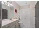Bathroom featuring a single sink vanity, neutral paint, tub, and shower with white tile for a clean and modern look at 10635 N Edgewater Pl, Johns Creek, GA 30097