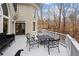 Relaxing outdoor deck with ample seating, perfect for entertaining guests with a view of the backyard at 10635 N Edgewater Pl, Johns Creek, GA 30097