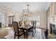 Dining room with elegant lighting, a fireplace, and neutral decor at 10635 N Edgewater Pl, Johns Creek, GA 30097