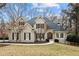 Charming brick home with a manicured lawn and well-maintained landscaping at 10635 N Edgewater Pl, Johns Creek, GA 30097