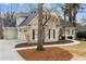 Lovely two-story home featuring a brick exterior, black shutters, a two-car garage, and mature trees at 10635 N Edgewater Pl, Johns Creek, GA 30097