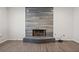 Modern fireplace with gray stacked tiles and black trim, and hardwood flooring at 10635 N Edgewater Pl, Johns Creek, GA 30097