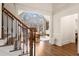 Inviting foyer showcasing hardwood floors, stairs, and a large window providing scenic views at 10635 N Edgewater Pl, Johns Creek, GA 30097