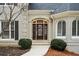Beautiful stained wood front door featuring leaded glass sidelights and arched transom window at 10635 N Edgewater Pl, Johns Creek, GA 30097