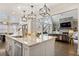Spacious kitchen island with stainless steel appliances and an open-concept living room at 10635 N Edgewater Pl, Johns Creek, GA 30097
