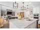 Open kitchen with a large island, stainless steel appliances, and a view into the living room at 10635 N Edgewater Pl, Johns Creek, GA 30097