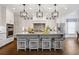 Modern kitchen featuring an island with seating, stainless steel appliances, and elegant pendant lighting at 10635 N Edgewater Pl, Johns Creek, GA 30097