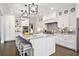 Spacious kitchen with a large center island, breakfast bar, and modern lighting fixtures at 10635 N Edgewater Pl, Johns Creek, GA 30097