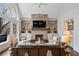 Cozy living room with a stone fireplace and built-in shelving at 10635 N Edgewater Pl, Johns Creek, GA 30097