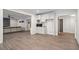 Open-concept living space with hardwood floors, with a modern fireplace feature and a built-in wet bar with a microwave at 10635 N Edgewater Pl, Johns Creek, GA 30097