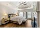 Spacious primary bedroom boasts a tray ceiling, fireplace, and hardwood floors at 10635 N Edgewater Pl, Johns Creek, GA 30097