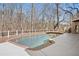 Inviting backyard pool with a deck and a peaceful wooded view provides an excellent spot for outdoor relaxation at 10635 N Edgewater Pl, Johns Creek, GA 30097