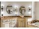 Elegant bathroom featuring dual oval mirrors and a beautiful marble countertop with stylish fixtures at 2616 Boddie Pl, Duluth, GA 30097