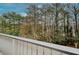Balcony offering a tranquil view of mature trees, perfect for enjoying nature and fresh air in a private setting at 3817 Paces Ferry West, Atlanta, GA 30339
