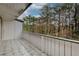 Private balcony with tiled flooring and a view of lush trees, providing a serene outdoor retreat at 3817 Paces Ferry West, Atlanta, GA 30339