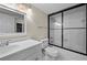 Clean bathroom with a glass door shower and tub combo, and a white vanity at 3817 Paces Ferry West, Atlanta, GA 30339