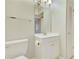 Bathroom with a single sink vanity, toilet, and louvered door at 3817 Paces Ferry West, Atlanta, GA 30339