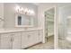 Bright bathroom with white vanity, large framed mirror, and access to a large closet with shelving and carpeted floors at 3817 Paces Ferry West, Atlanta, GA 30339