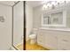 Bright bathroom with a glass shower, white cabinets, and a large mirror, creating a clean and modern space at 3817 Paces Ferry West, Atlanta, GA 30339