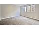 A bright bedroom features neutral paint, plush carpet, and a large window at 3817 Paces Ferry West, Atlanta, GA 30339