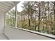 View from the covered wooden deck featuring an overlook of the trees at 3817 Paces Ferry West, Atlanta, GA 30339