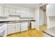 Bright kitchen with white cabinets, wine fridge, and hardwood floors at 3817 Paces Ferry West, Atlanta, GA 30339