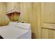 Laundry area with a white washing machine and wood paneled walls at 3817 Paces Ferry West, Atlanta, GA 30339