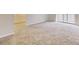 Living room with neutral carpet, sliding glass door, and view into the kitchen at 3817 Paces Ferry West, Atlanta, GA 30339