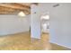 Open living room leading into the kitchen, featuring hardwood floors and an inviting space for entertaining and relaxation at 3817 Paces Ferry West, Atlanta, GA 30339