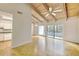 Bright living room with wood floors, exposed beams, and sliding doors to the balcony at 3817 Paces Ferry West, Atlanta, GA 30339