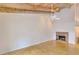 Bright living room featuring hardwood floors, a fireplace, and exposed wood beams adding character and charm to the home at 3817 Paces Ferry West, Atlanta, GA 30339