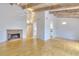 Spacious living room with wood floors, high ceilings, exposed wood beams, and a brick fireplace creating a warm and inviting atmosphere at 3817 Paces Ferry West, Atlanta, GA 30339