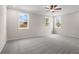 Spacious bedroom with neutral walls, gray carpet, ceiling fan, and large windows letting in plenty of light at 727 Crossroad Ct, Powder Springs, GA 30127