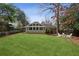 Expansive backyard featuring a well-maintained lawn and a charming outdoor seating area at 1039 Northcliffe Nw Dr, Atlanta, GA 30318