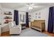 Charming Bedroom with crib, glider, shelving, and natural light at 1039 Northcliffe Nw Dr, Atlanta, GA 30318