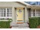 Close up of a yellow front door, set into the light brick of a charming home at 1039 Northcliffe Nw Dr, Atlanta, GA 30318