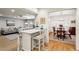 Open layout with a breakfast bar connecting to the dining room and adjacent living area at 1039 Northcliffe Nw Dr, Atlanta, GA 30318