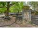 A playground is located in a park with mature trees and green space with picnic tables at 1039 Northcliffe Nw Dr, Atlanta, GA 30318