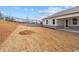 Side view of backyard with sod and rear home facade at 1723 Juniper Berry Way, Loganville, GA 30052