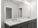 Double sinks with dark cabinets and granite countertops in bathroom at 1723 Juniper Berry Way, Loganville, GA 30052