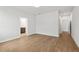 Bedroom with neutral walls, wood-look floors, and two doorways at 1723 Juniper Berry Way, Loganville, GA 30052