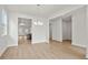 Open floor plan with neutral paint, modern lighting and views into other rooms at 1723 Juniper Berry Way, Loganville, GA 30052