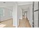 Hallway with hardwood floors, neutral paint, and views into other rooms at 1723 Juniper Berry Way, Loganville, GA 30052