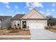 Charming home featuring stone accents, neutral siding, well-manicured lawn and two-car garage at 1723 Juniper Berry Way, Loganville, GA 30052