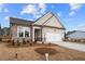 New construction home with stone accents, a two-car garage and landscaping in the front yard at 1723 Juniper Berry Way, Loganville, GA 30052