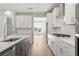 Modern kitchen featuring stainless steel appliances, a large island with sink, and eat-in breakfast nook at 1723 Juniper Berry Way, Loganville, GA 30052