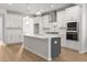Kitchen featuring white cabinetry, stainless steel appliances, light countertops, and hardwood floors at 1723 Juniper Berry Way, Loganville, GA 30052