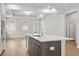 Bright open kitchen boasts a large island with sink, stainless steel appliances, and eat-in breakfast nook at 1723 Juniper Berry Way, Loganville, GA 30052
