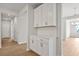 Stylish kitchen features ample white cabinets, a subway tile backsplash, quartz countertops, and stainless steel appliances at 1723 Juniper Berry Way, Loganville, GA 30052